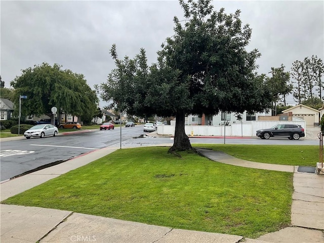 view of street with sidewalks, curbs, and street lighting