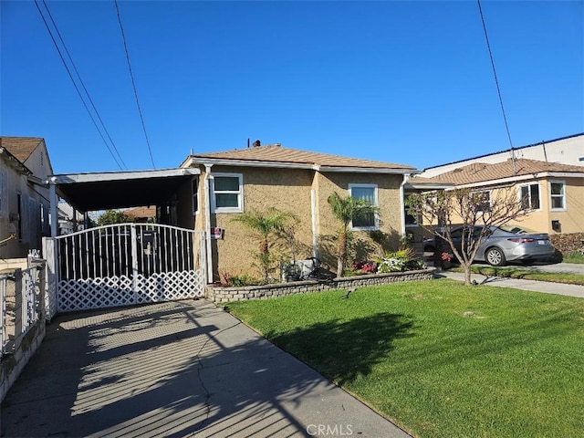 view of front of home featuring a front lawn, a carport, and stucco siding