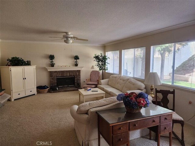 carpeted living room featuring a textured ceiling, crown molding, a brick fireplace, and ceiling fan