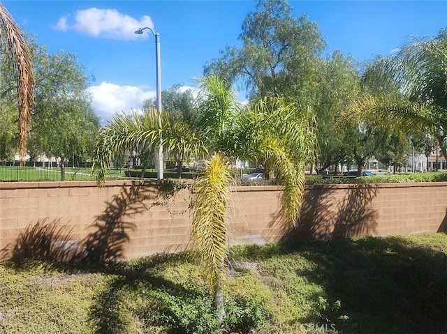 view of home's community with fence