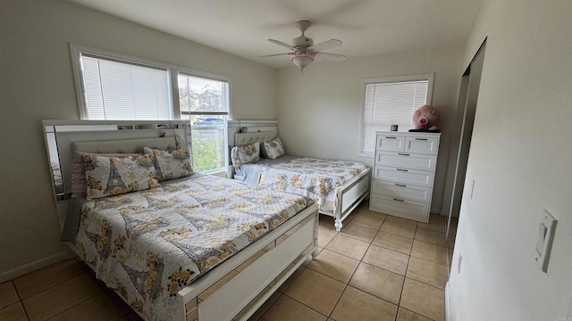 bedroom with light tile patterned floors and a ceiling fan