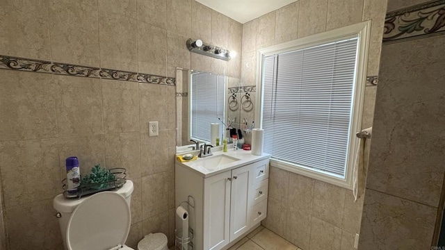 bathroom featuring tile patterned floors, toilet, tile walls, and vanity