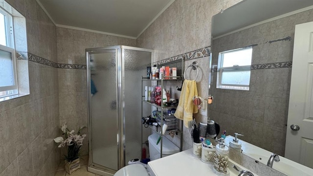 full bathroom featuring a stall shower, toilet, tile walls, and ornamental molding