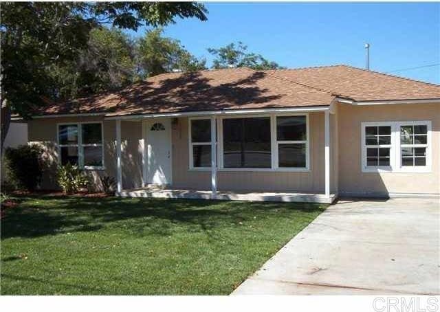 ranch-style home with stucco siding and a front yard