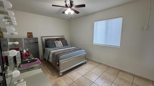 bedroom with light tile patterned floors, baseboards, and ceiling fan