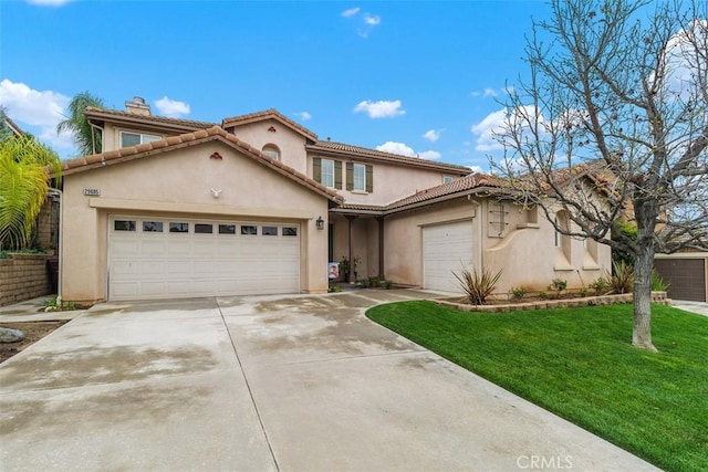 mediterranean / spanish-style home featuring a tiled roof, a front yard, stucco siding, driveway, and an attached garage