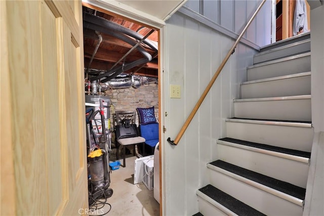 23679 Hillside Dr, Crestline, CA 92325 - stairs featuring unfinished concrete flooring and water heater