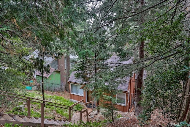 23679 Hillside Dr, Crestline, CA 92325 - view of front facade featuring board and batten siding and fence