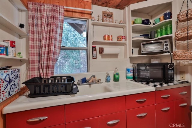 23679 Hillside Dr, Crestline, CA 92325 - kitchen featuring yellow cabinets, black microwave, open shelves, and red cabinetry