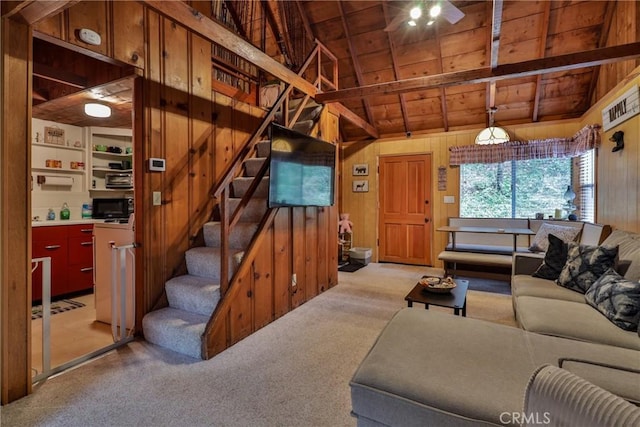 23679 Hillside Dr, Crestline, CA 92325 - living room with light colored carpet, wooden ceiling, wooden walls, and stairs