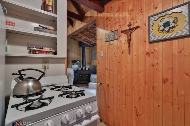 23679 Hillside Dr, Crestline, CA 92325 - interior space with a wood stove, wooden walls, and white gas range
