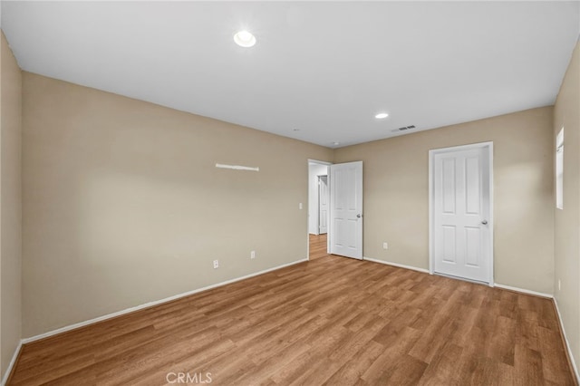 unfurnished bedroom featuring recessed lighting, baseboards, light wood finished floors, and visible vents