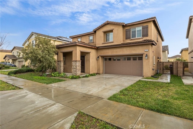 mediterranean / spanish-style house with stucco siding, an attached garage, concrete driveway, and a gate