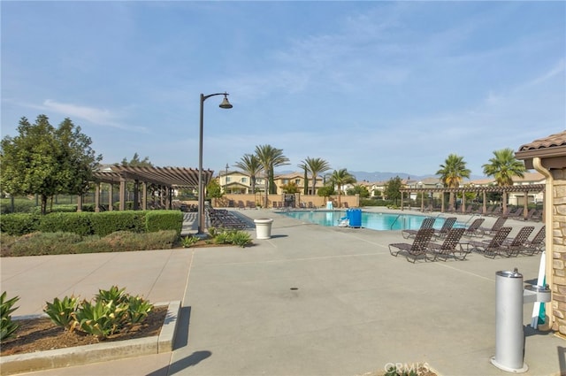 pool featuring a pergola and a patio area