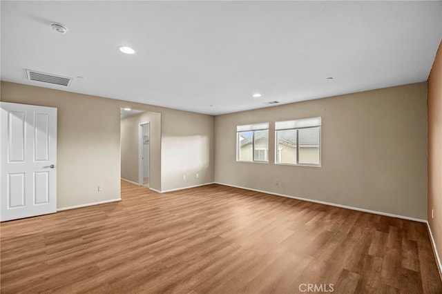 empty room with baseboards, recessed lighting, visible vents, and light wood-style floors