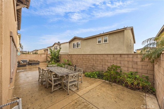 view of patio / terrace featuring an outdoor living space, outdoor dining area, and a fenced backyard