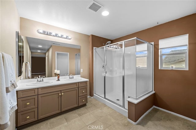 full bath with a sink, a stall shower, and visible vents