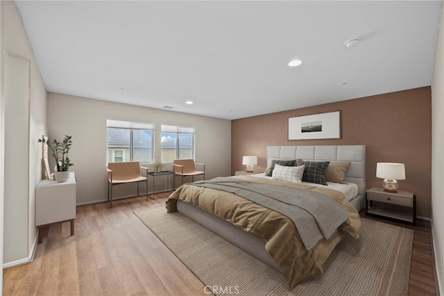 bedroom with baseboards, visible vents, light wood-style flooring, and recessed lighting