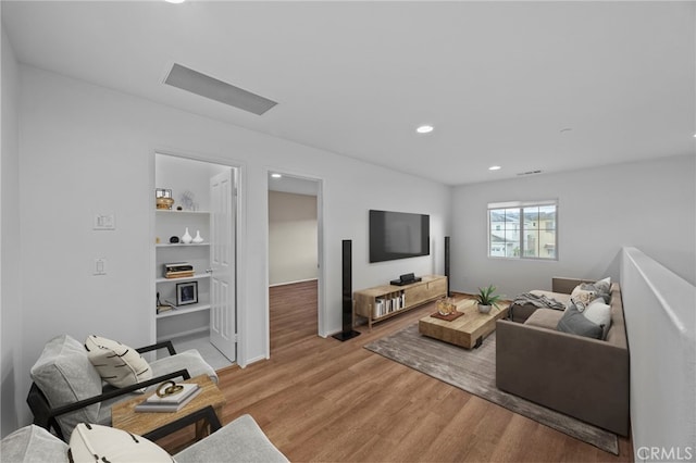 living room with light wood-style floors and recessed lighting