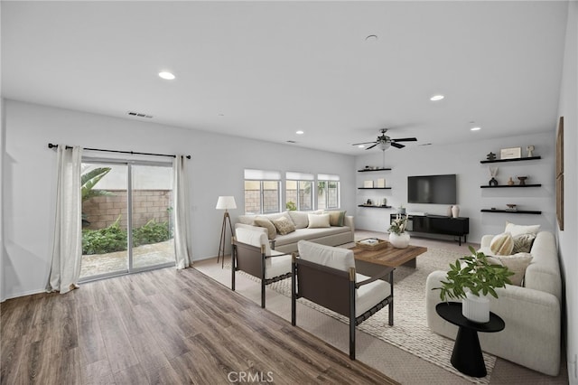 living room featuring visible vents, recessed lighting, a ceiling fan, and wood finished floors