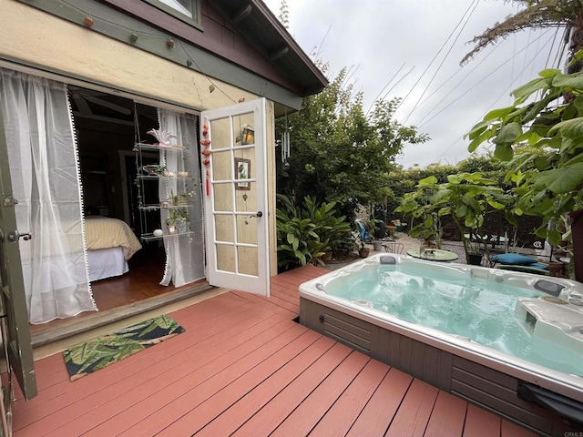 deck featuring hot tub deck surround