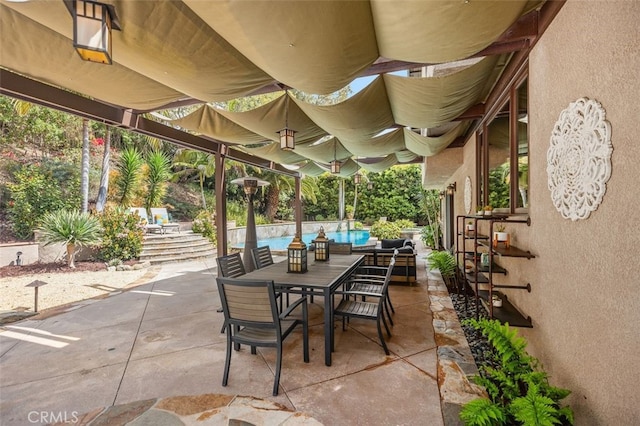 view of patio / terrace featuring an outdoor pool and outdoor dining area