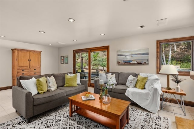 living room with light tile patterned floors, baseboards, and recessed lighting
