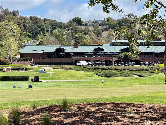 surrounding community featuring a yard and golf course view