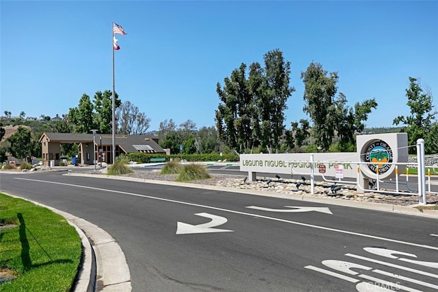 view of road with street lights and curbs