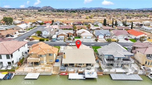 birds eye view of property with a residential view and a water and mountain view