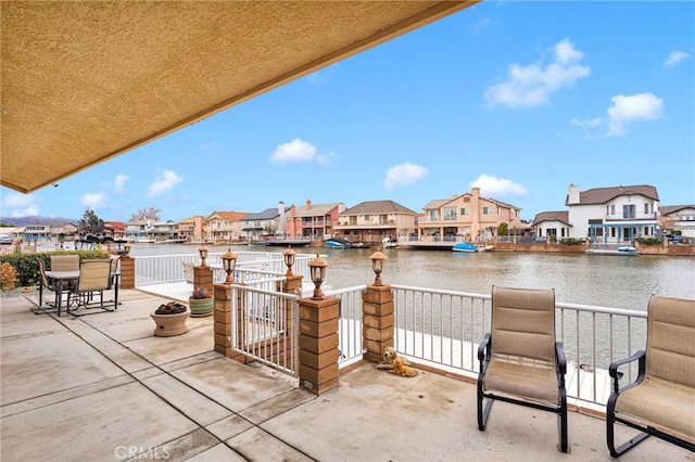 view of patio featuring a residential view and a water view