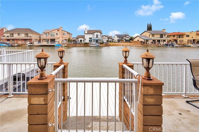 view of dock featuring a residential view and a water view