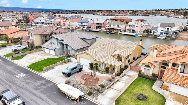 drone / aerial view with a residential view and a water view