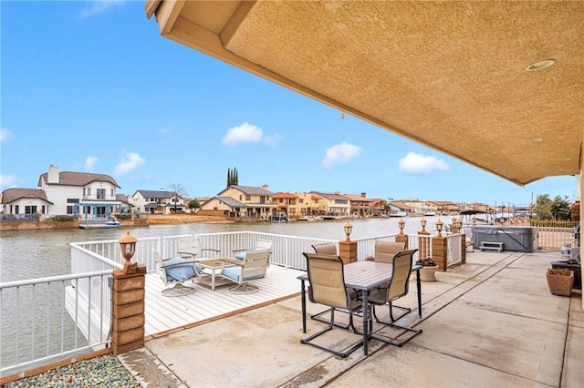 view of patio with a residential view and a water view