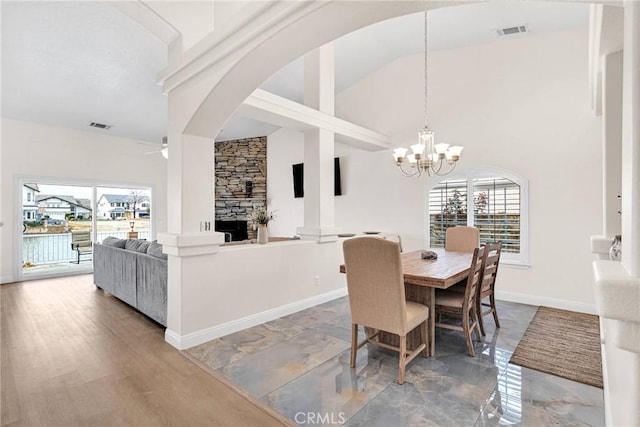 dining room featuring visible vents, baseboards, a healthy amount of sunlight, and a fireplace