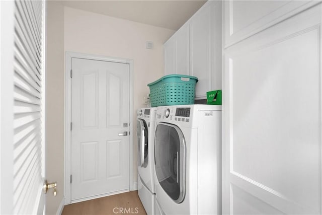 washroom featuring washer and dryer and light wood-type flooring