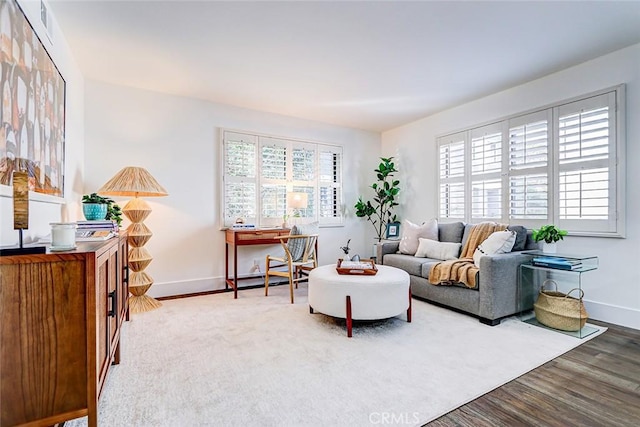 living room featuring visible vents, wood finished floors, and baseboards