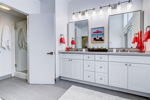 full bath featuring a shower stall, double vanity, and a sink