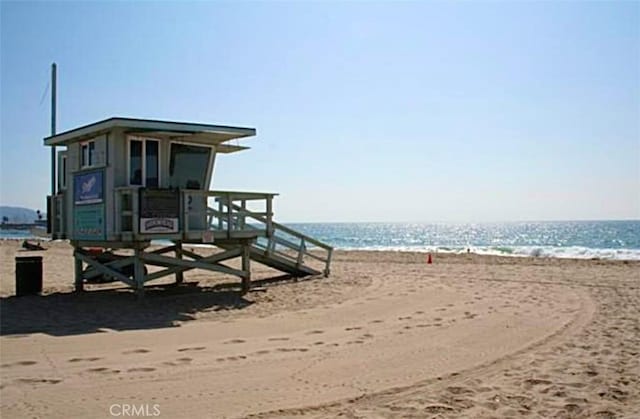 exterior space featuring a beach view and a water view