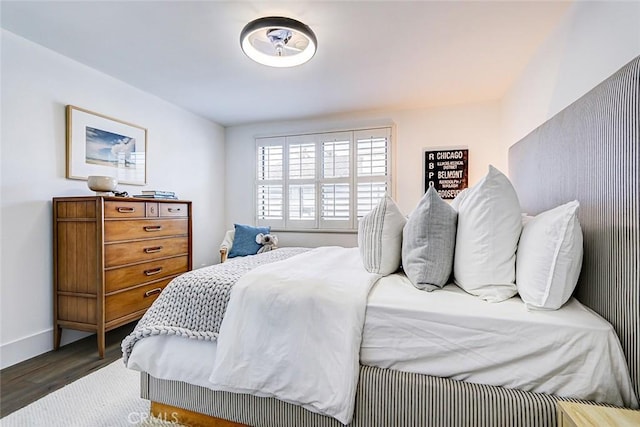 bedroom featuring baseboards and wood finished floors