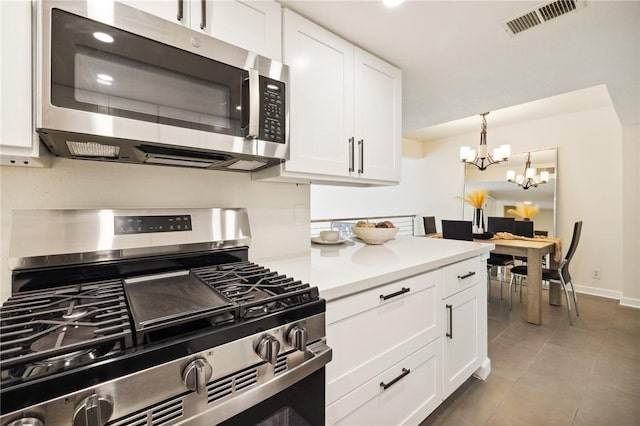 380 W Wilson St Unit A102, Costa Mesa, CA 92627 - kitchen with appliances with stainless steel finishes, a chandelier, and white cabinetry