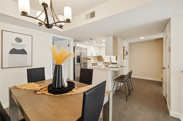 380 W Wilson St Unit A102, Costa Mesa, CA 92627 - tiled dining space featuring a chandelier and recessed lighting