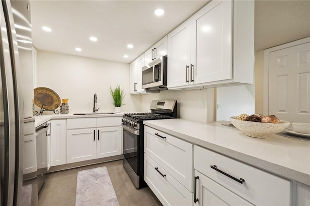 380 W Wilson St Unit A102, Costa Mesa, CA 92627 - kitchen featuring appliances with stainless steel finishes, white cabinetry, recessed lighting, light stone countertops, and tile patterned floors