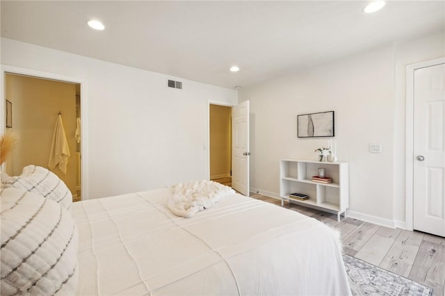 380 W Wilson St Unit A102, Costa Mesa, CA 92627 - bedroom with light wood-style floors and recessed lighting