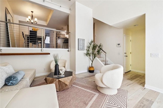 380 W Wilson St Unit A102, Costa Mesa, CA 92627 - living room featuring wood finished floors and a chandelier