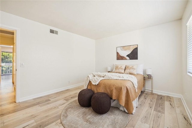 380 W Wilson St Unit A102, Costa Mesa, CA 92627 - bedroom with light wood finished floors and multiple windows