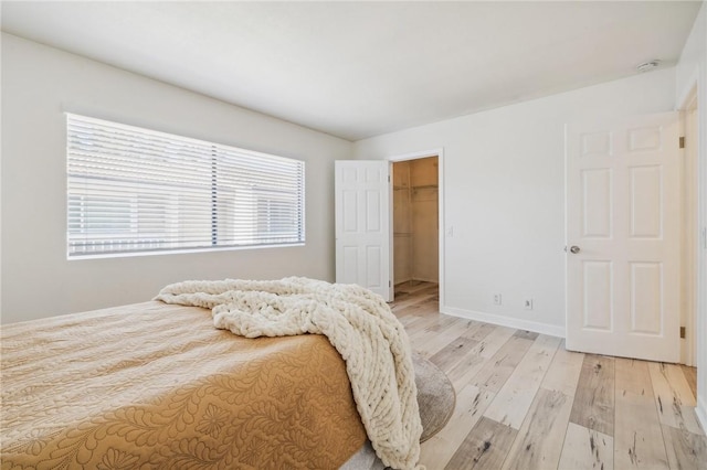 380 W Wilson St Unit A102, Costa Mesa, CA 92627 - bedroom featuring light wood-style flooring and a spacious closet