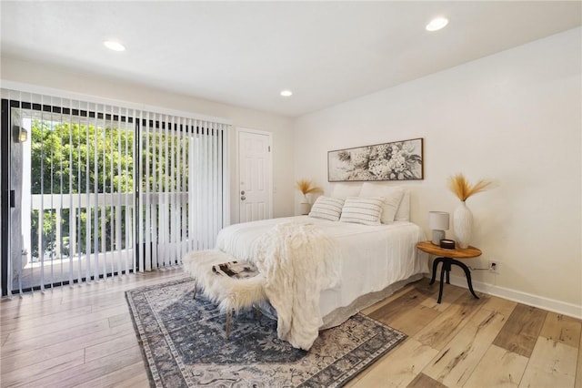 380 W Wilson St Unit A102, Costa Mesa, CA 92627 - bedroom with light wood finished floors, recessed lighting, and access to outside