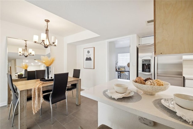 380 W Wilson St Unit A102, Costa Mesa, CA 92627 - tiled dining area featuring a chandelier and baseboards