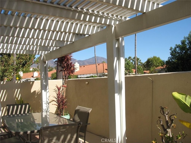 view of patio / terrace with a mountain view, fence, outdoor dining space, and a pergola